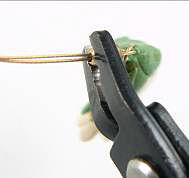 Crimping pliers crimping a crimp cover over wire